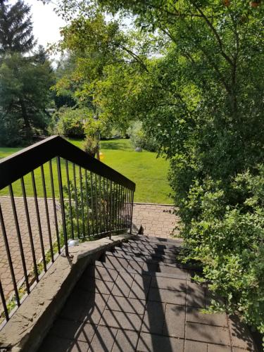 a walkway with a black fence and a park at Window Hill in St. Albert