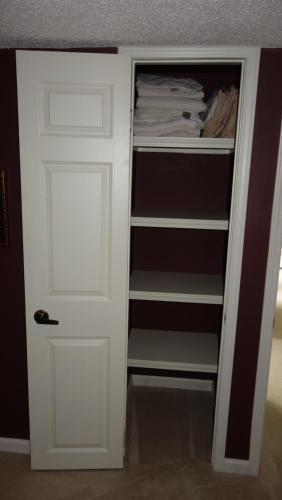 a closet with a white door in a room at Window Hill in St. Albert