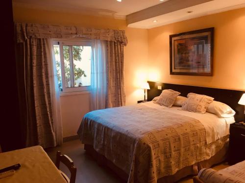 a bedroom with a large bed and a window at Hotel A&B Internacional in Buenos Aires