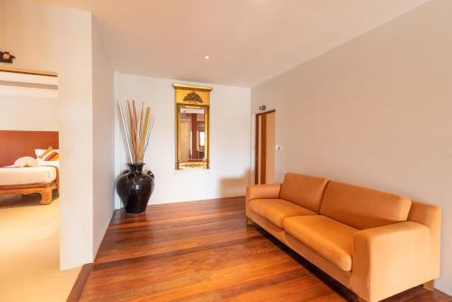 a living room with a couch and a bed at Wandee Garden in Choeng Mon Beach