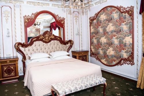 a bedroom with a white bed and a mirror at Lion Hotel in Astana