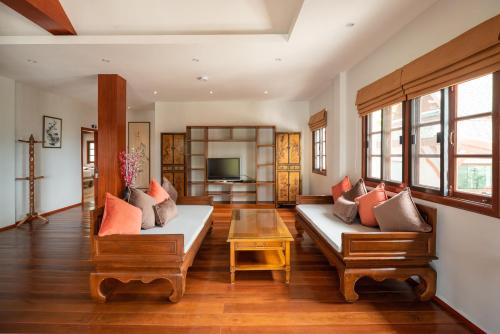 a living room with two couches and a table at Wandee Garden in Choeng Mon Beach