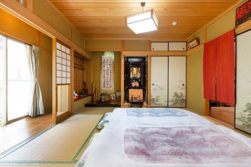 a bedroom with a large bed in a room at AbbeyRoad Inn Seika in Seika