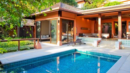 a house with a swimming pool and a patio at Sri Panwa Phuket Luxury Pool Villa Hotel - SHA Plus in Panwa Beach