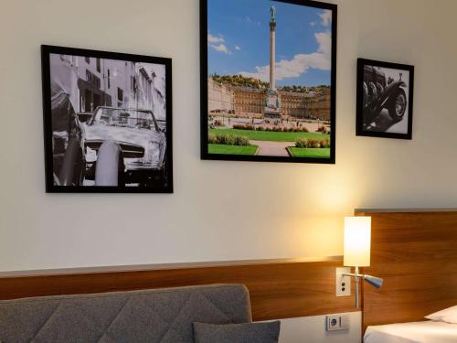 a hotel room with three pictures on the wall at Mercure Stuttgart Sindelfingen an der Messe in Sindelfingen