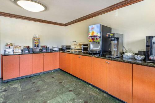 a large kitchen with orange cabinets in a room at Econo Lodge Florence - Darlington in Florence