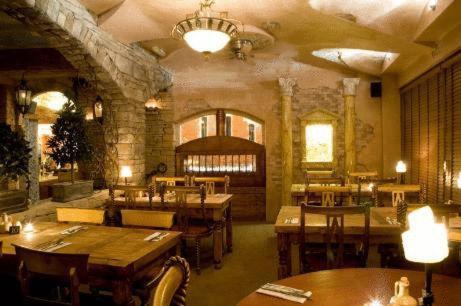 a restaurant with wooden tables and chairs in a room at The Blueberry Hotel in Pontypridd