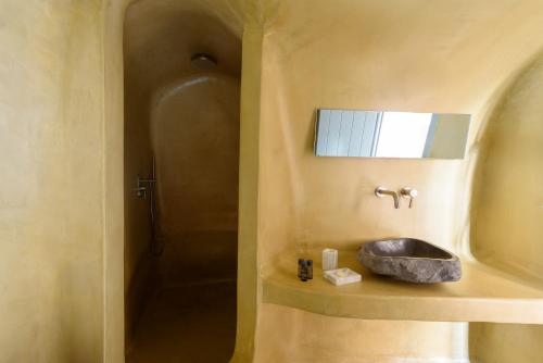a bathroom with a sink and a shower at Sublime Villa & Caves in Akrotiri