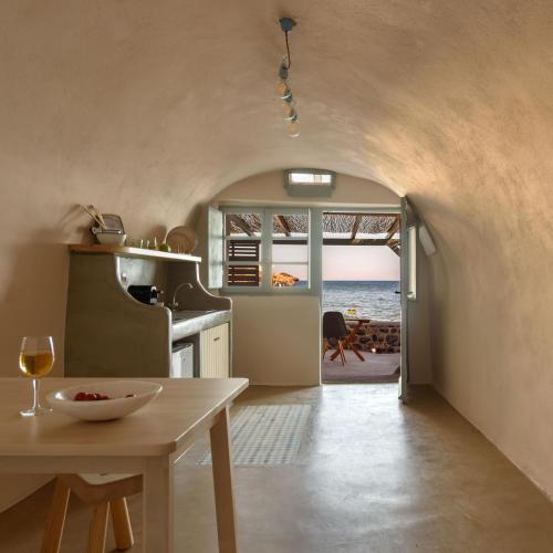 a kitchen with a table and a view of the ocean at Sublime Villa & Caves in Akrotiri