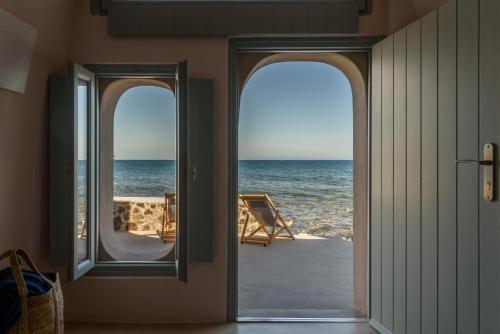 an open door to the ocean from a house at Sublime Villa & Caves in Akrotiri