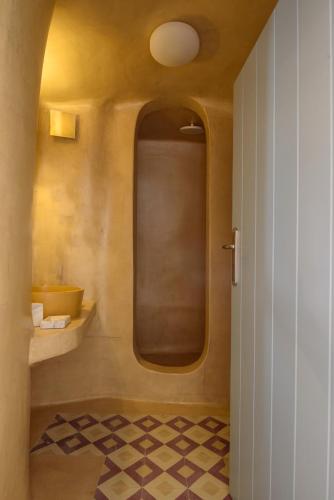 a bathroom with a sink and a toilet in a room at Sublime Villa & Caves in Akrotiri