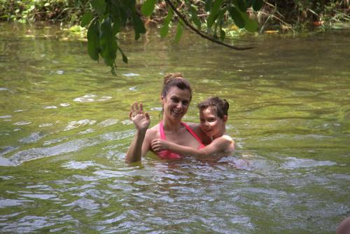 a woman and a child are in the water at LakeSide Cabana Tissamaharama in Tissamaharama