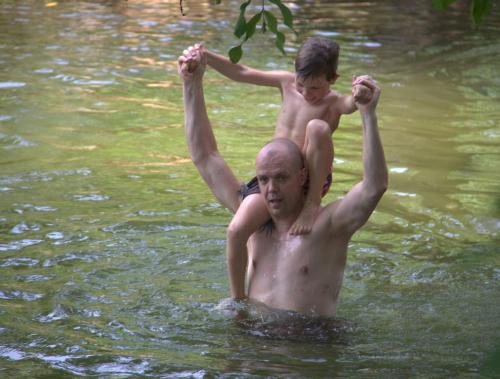 a man and a boy are in the water at LakeSide Cabana Tissamaharama in Tissamaharama