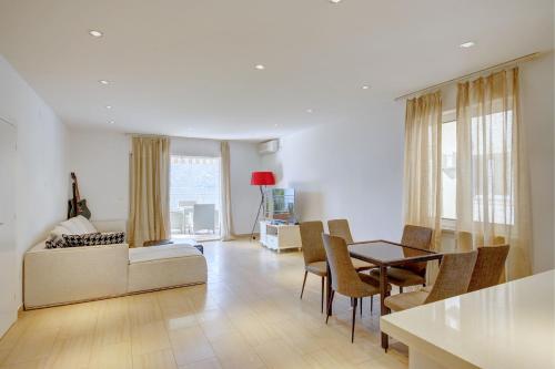 a living room with a bed and a table and chairs at Fashion Beach Apartments in Risan