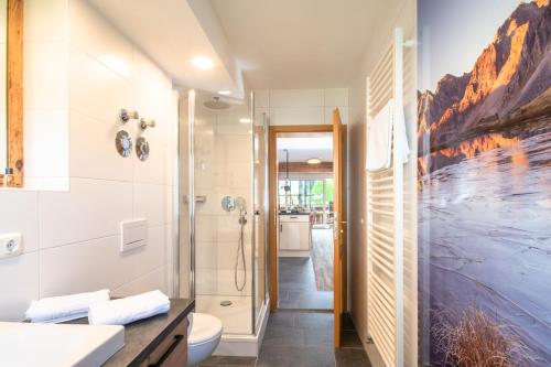 a bathroom with a shower and a toilet at Landhaus Dodel in Oberstdorf