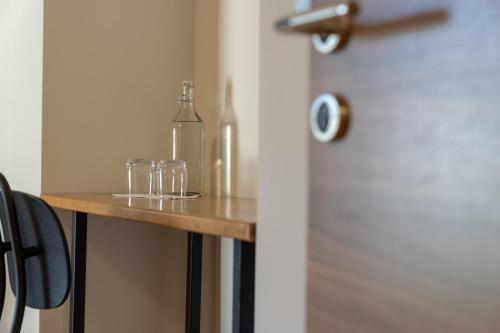 a table with glasses and bottles on top of it at Pr' Kramarju - House in the heart of Kobarid in Kobarid