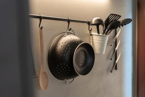 a kitchen utensils are hanging on a wall at Pr' Kramarju - House in the heart of Kobarid in Kobarid