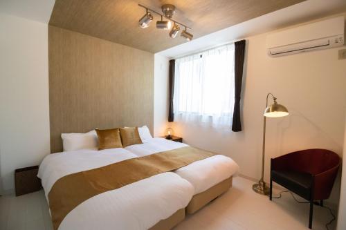 a bedroom with a large bed and a window at beautiful Mt.Fuji B in Fujikawaguchiko