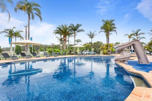 a swimming pool with a slide in a resort at Mountain View Resort in Shoalhaven Heads