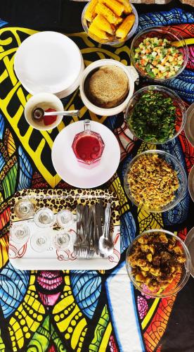 a table with many plates of food on it at Yog Hostel- Rooftop Yoga & Backpacker Social Stay in Thamel, Kathamndu in Kathmandu