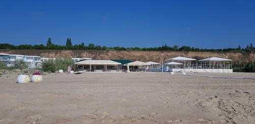 a group of tents on a sandy beach at Грибовка Апартаменты 134 - 137 Black Sea Bugaz in Gribovka