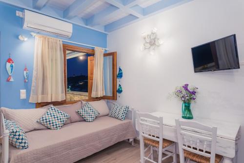 ein Wohnzimmer mit einem Sofa und einem Tisch in der Unterkunft House of Arts in Kokkari