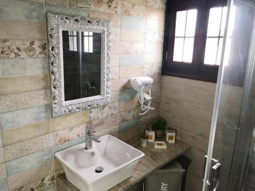 a bathroom with a sink and a mirror at Amaryllis in Moudhros