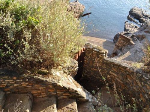 a stone wall next to a body of water at Villa Peducelli by Agenzia SolturElba in Capoliveri