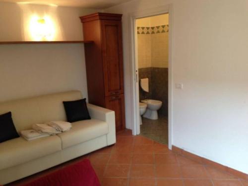 a living room with a couch and a bathroom at Villa Peducelli by Agenzia SolturElba in Capoliveri