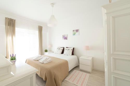 Ένα ή περισσότερα κρεβάτια σε δωμάτιο στο The Yellow House Cascais