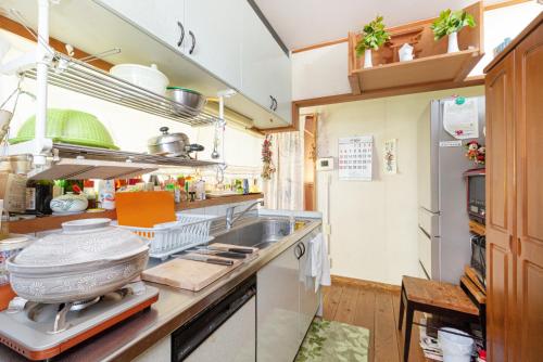a kitchen with a sink and a counter top at AbbeyRoad Inn Seika in Seika