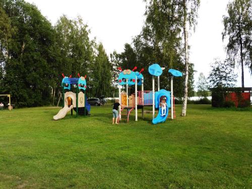 two children playing on a playground in a park at Bjursås Berg & Sjö in Bjursås