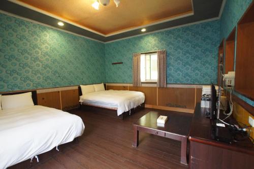 Cama o camas de una habitación en 蓬萊生態農場仙山民宿