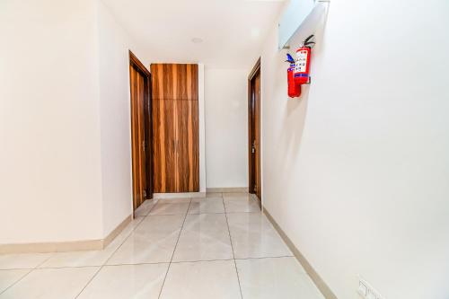 a hallway with two doors and a fire hydrant on a wall at FabHotel Kiara- 400 meters from Medanta hospital in Gurgaon