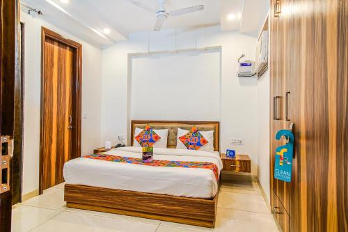 a bedroom with a large bed in a room at FabHotel Kiara- 400 meters from Medanta hospital in Gurgaon