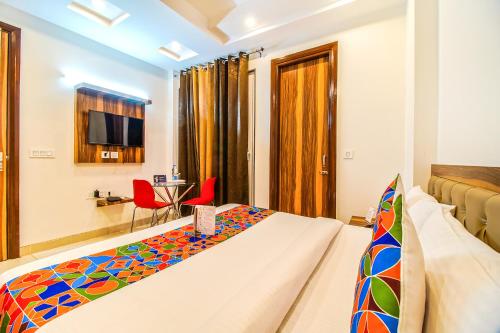 a hotel room with a bed and a television at FabHotel Kiara- 400 meters from Medanta hospital in Gurgaon