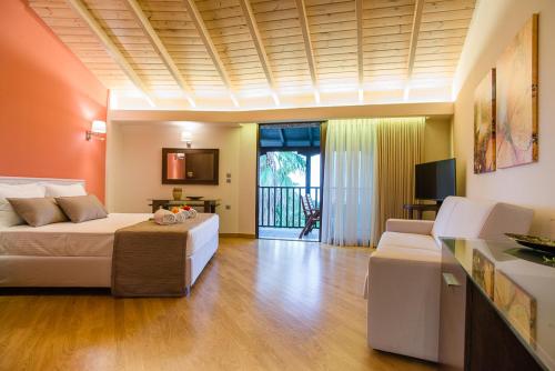 a large living room with a bed and a couch at Nepheli Hotel in Kastrosikia