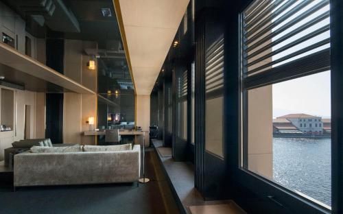 a living room with a couch and a large window at Key Hotel in Izmir