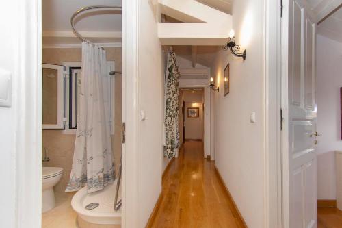 a hallway leading to a bathroom with a toilet at Stella's Attic in Spianada - Old town in Corfu