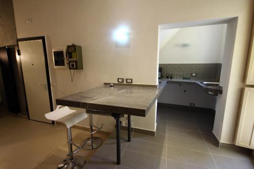 a kitchen with a counter and a sink in a room at Khalisah in Palermo