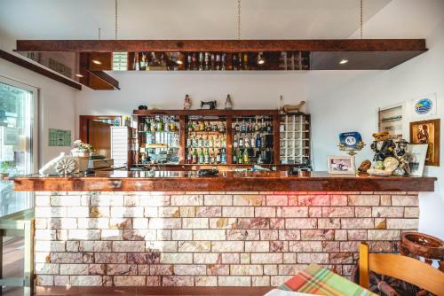 a brick wall with a bar in a restaurant at Hotel Ikaros in Archangelos
