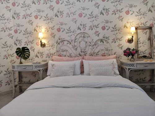 a bedroom with a white bed with two night stands at Casa con Cuevita in Teror