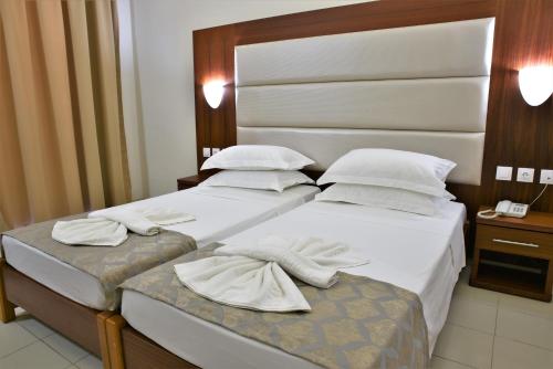 Ένα ή περισσότερα κρεβάτια σε δωμάτιο στο Marathon Hotel - All Inclusive