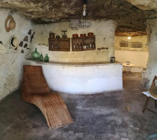 a room with a bar in a stone building at Casa con Cuevita in Teror