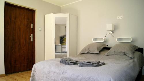 a bedroom with a bed with towels on it at Mini Studio in Augustów