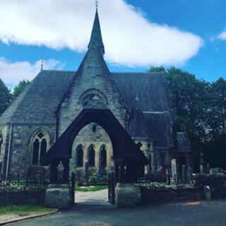 an old stone church with an arch in front of it at Alderdale B&B in Luss