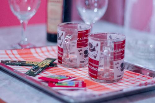 two empty glasses sitting on a table with wine glasses at Galavani in Tbilisi City
