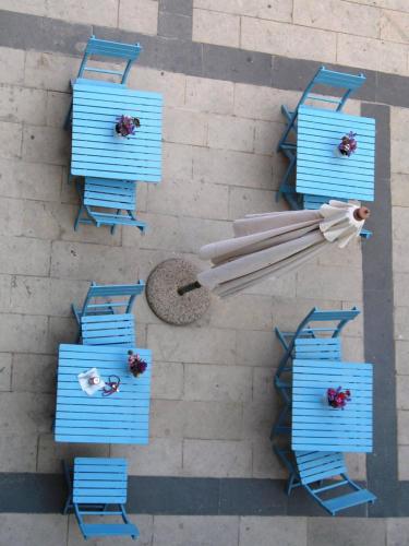 an overhead view of blue chairs and umbrellas at Antica Dimora San Girolamo in Licata