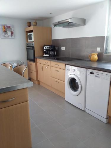 a kitchen with a white washing machine in it at Appartement T2 in Moliets-et-Maa