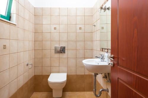 a bathroom with a toilet and a sink at Anemos Villa in Sálakos
